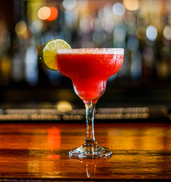 Margarita shaped glass with a lime wedge